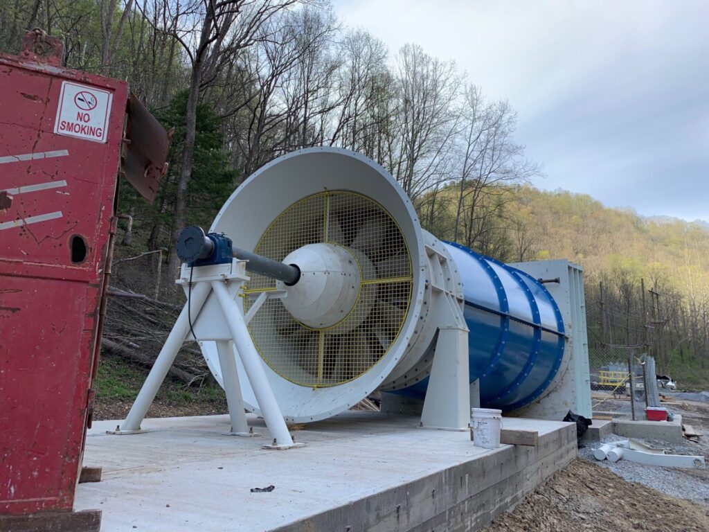 blue and white Coal extraction fan above ground on a mine site